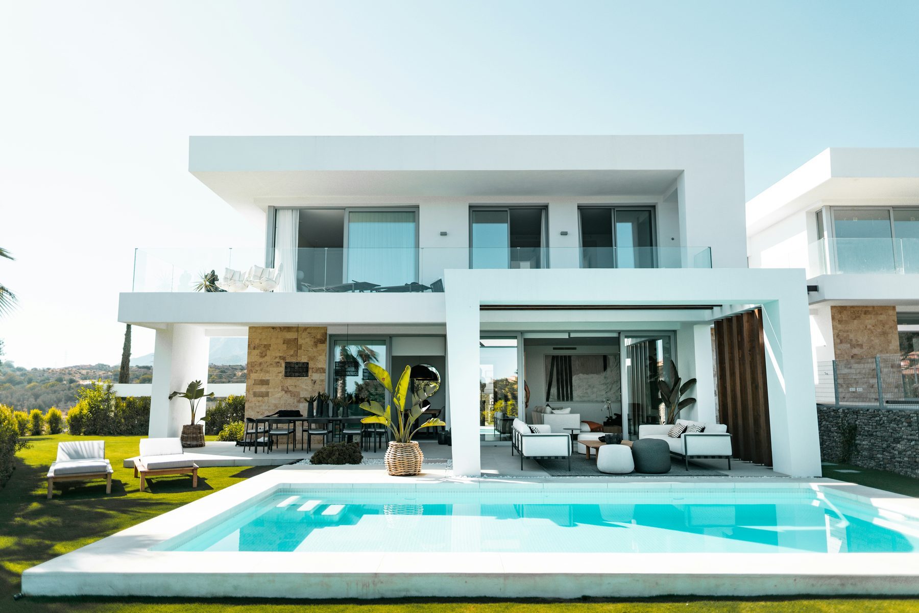 Modern luxury home with pool, representing buying a house