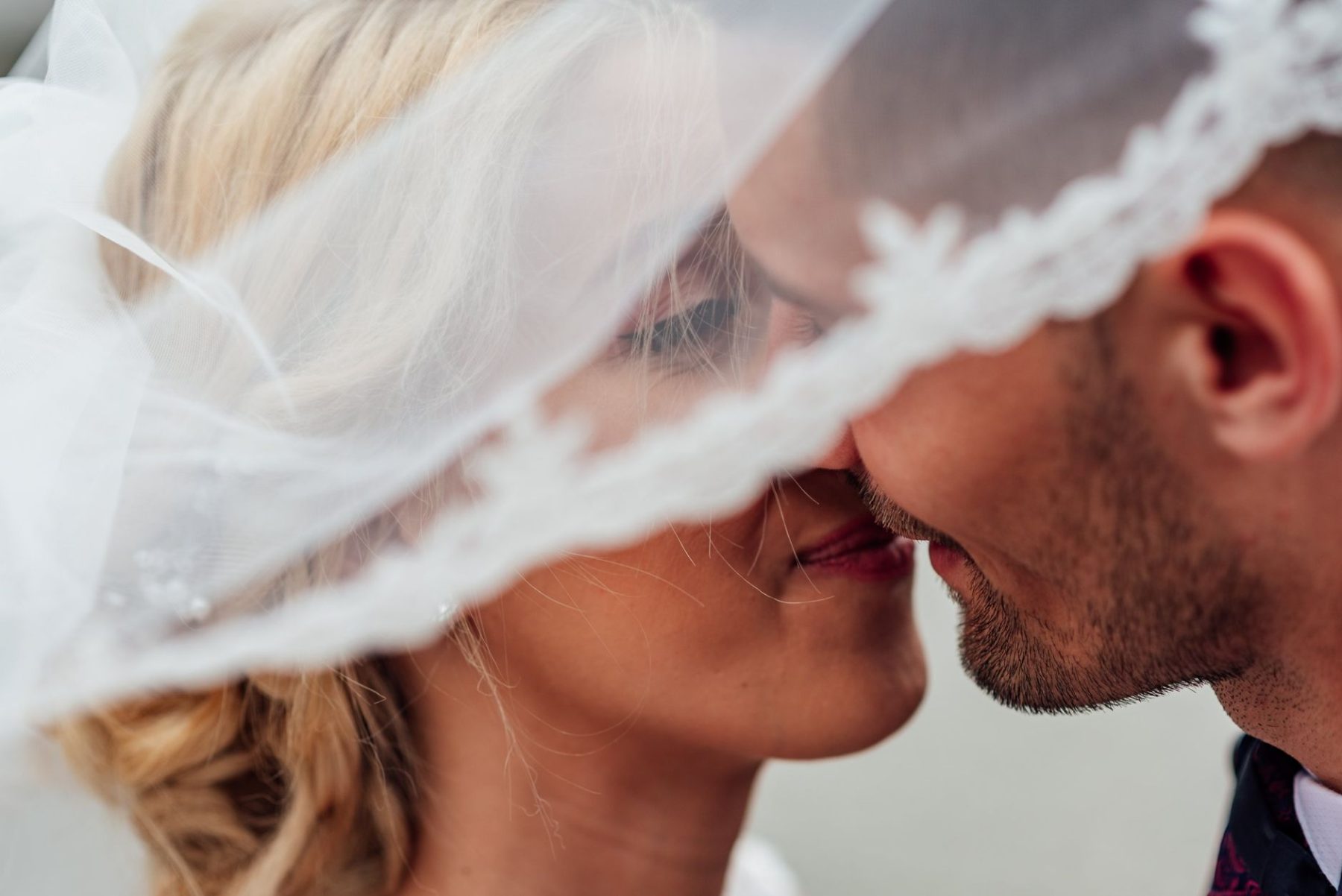 Groom and bride kissing after preparing for marriage