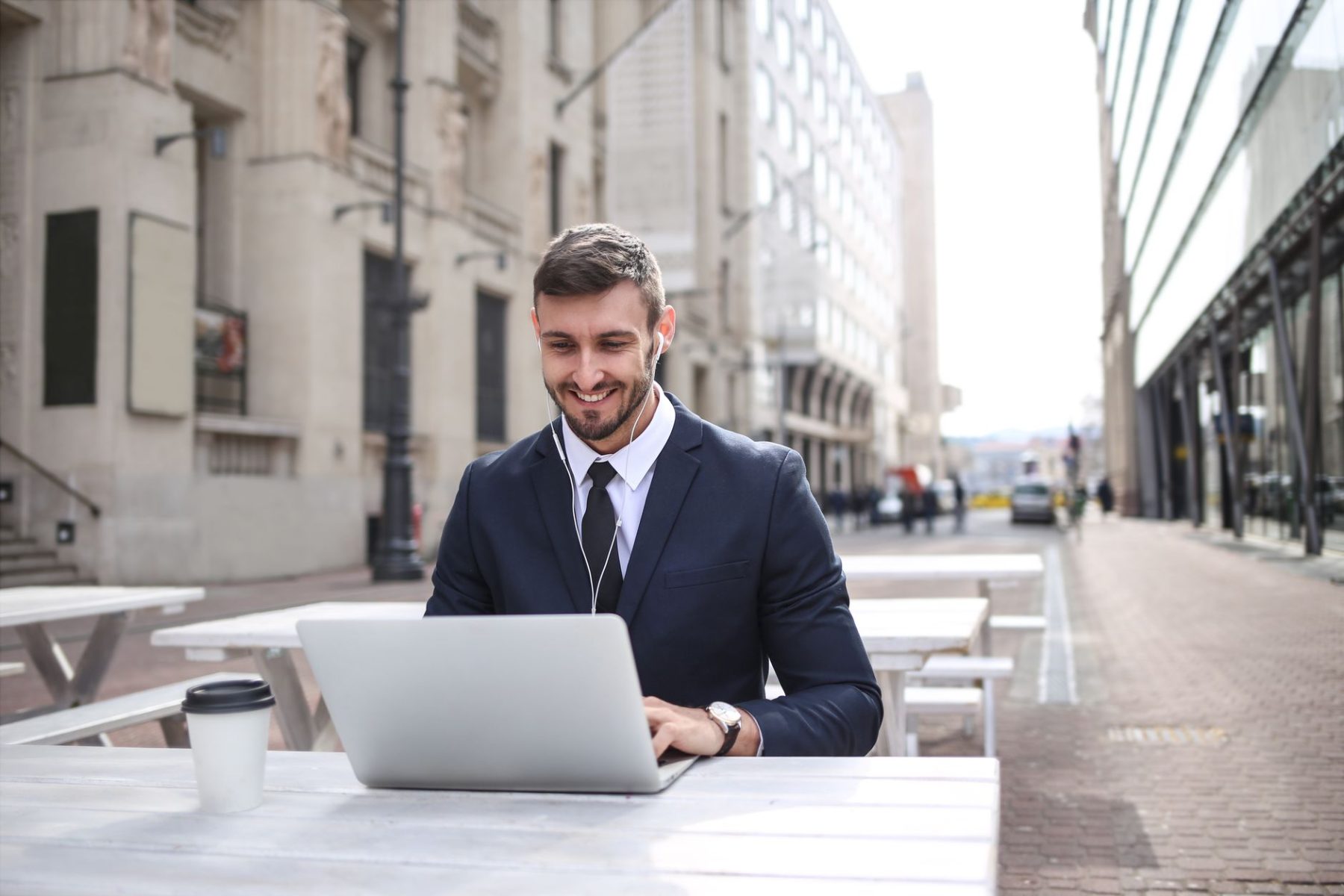 Man in black suit jacket using a laptop while starting a blog