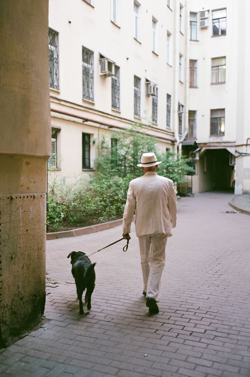 Man walking outside with his new dog after adopting a pet