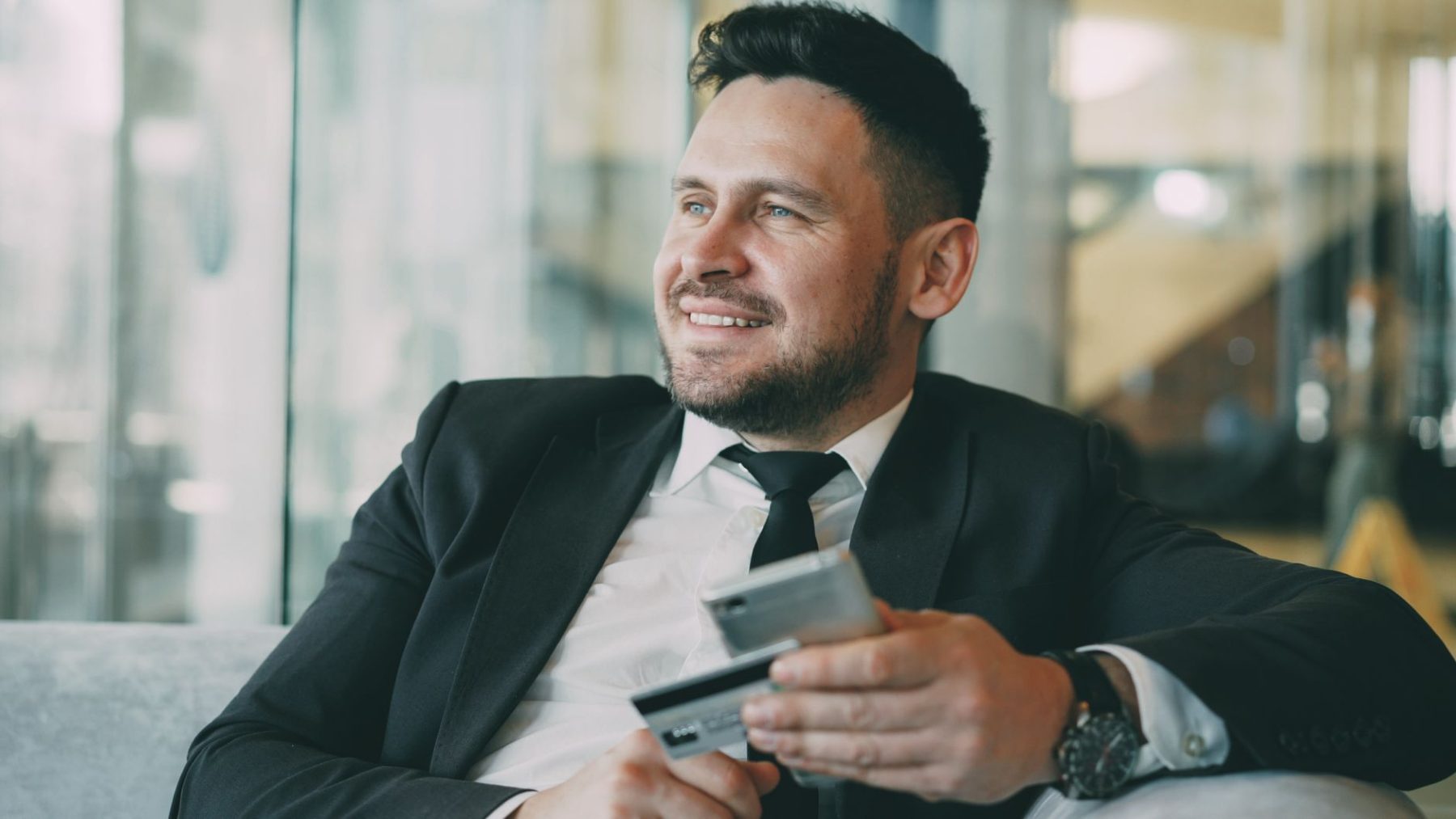wealthy business man holding a credit card