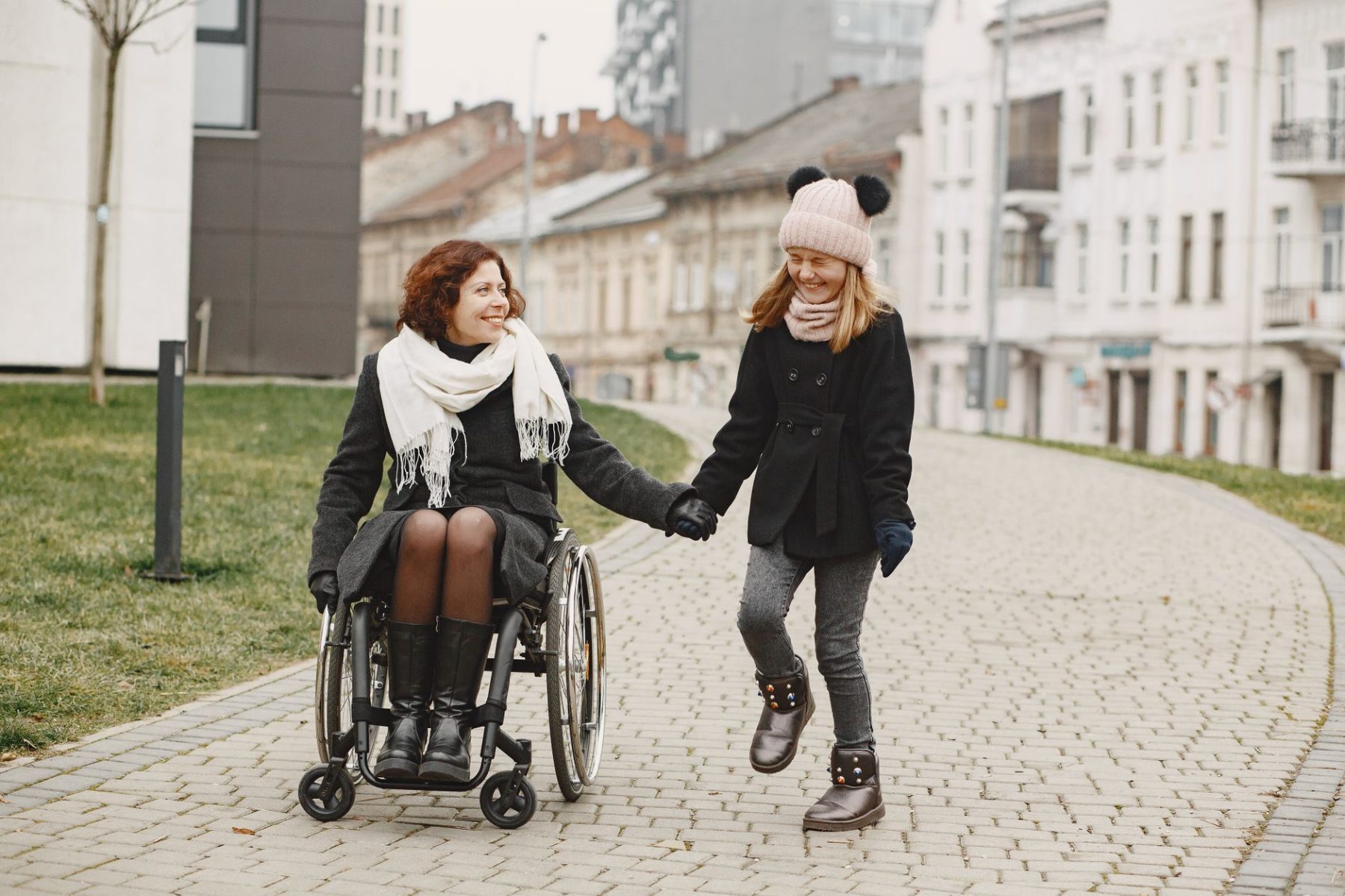 Woman in a wheelchair with her daughter after applying for disability