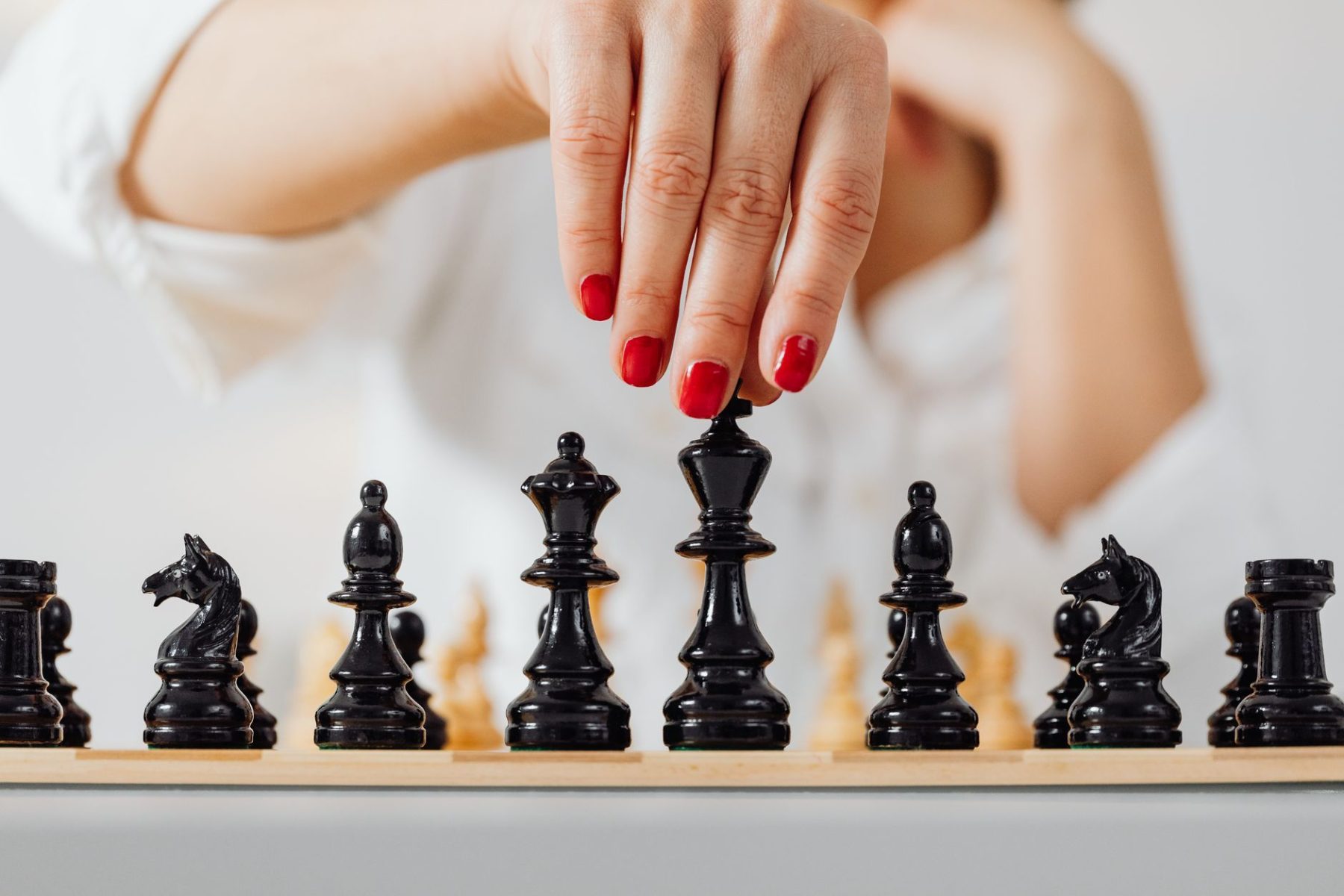 A close-up shot of a wooden chessboard with focus on a few pieces, symbolizing strategic thinking and long-term decision-making.