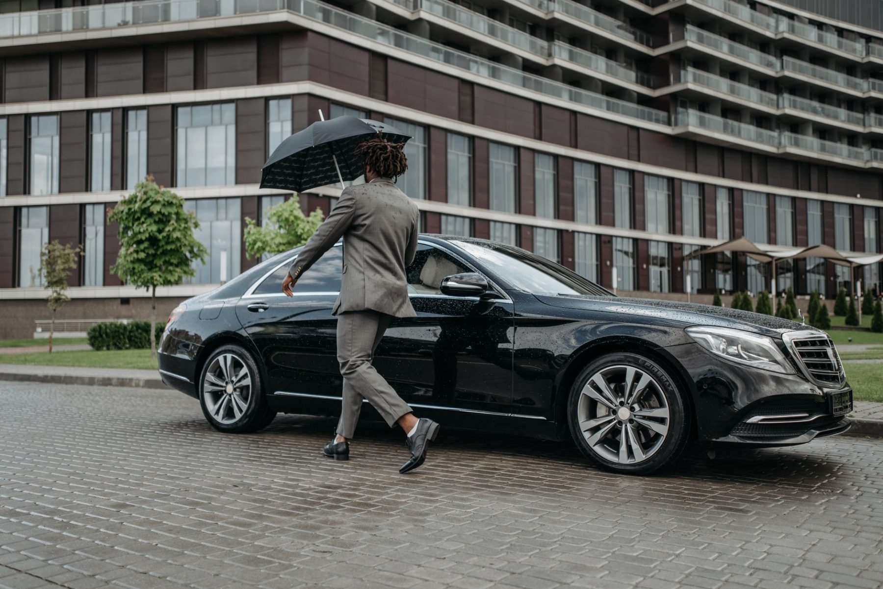 Man getting into his car in the rain after quitting his job