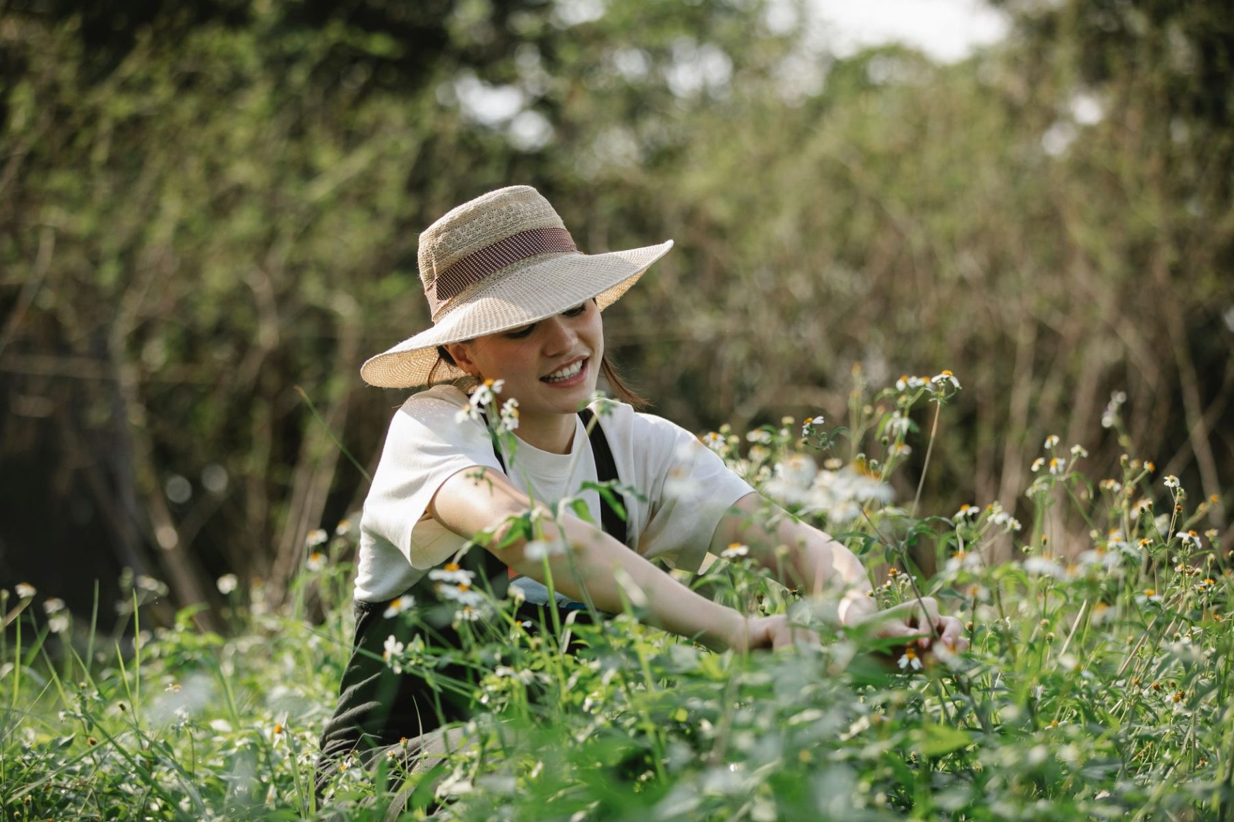 A person tending to flowers and plants while enjoying spring gardening, representing self-care, personal wellness, and a fresh start.