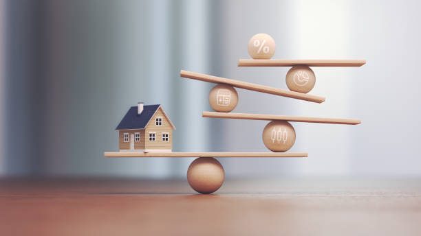 Small house balanced on a scale representing stability and security in adulthood
